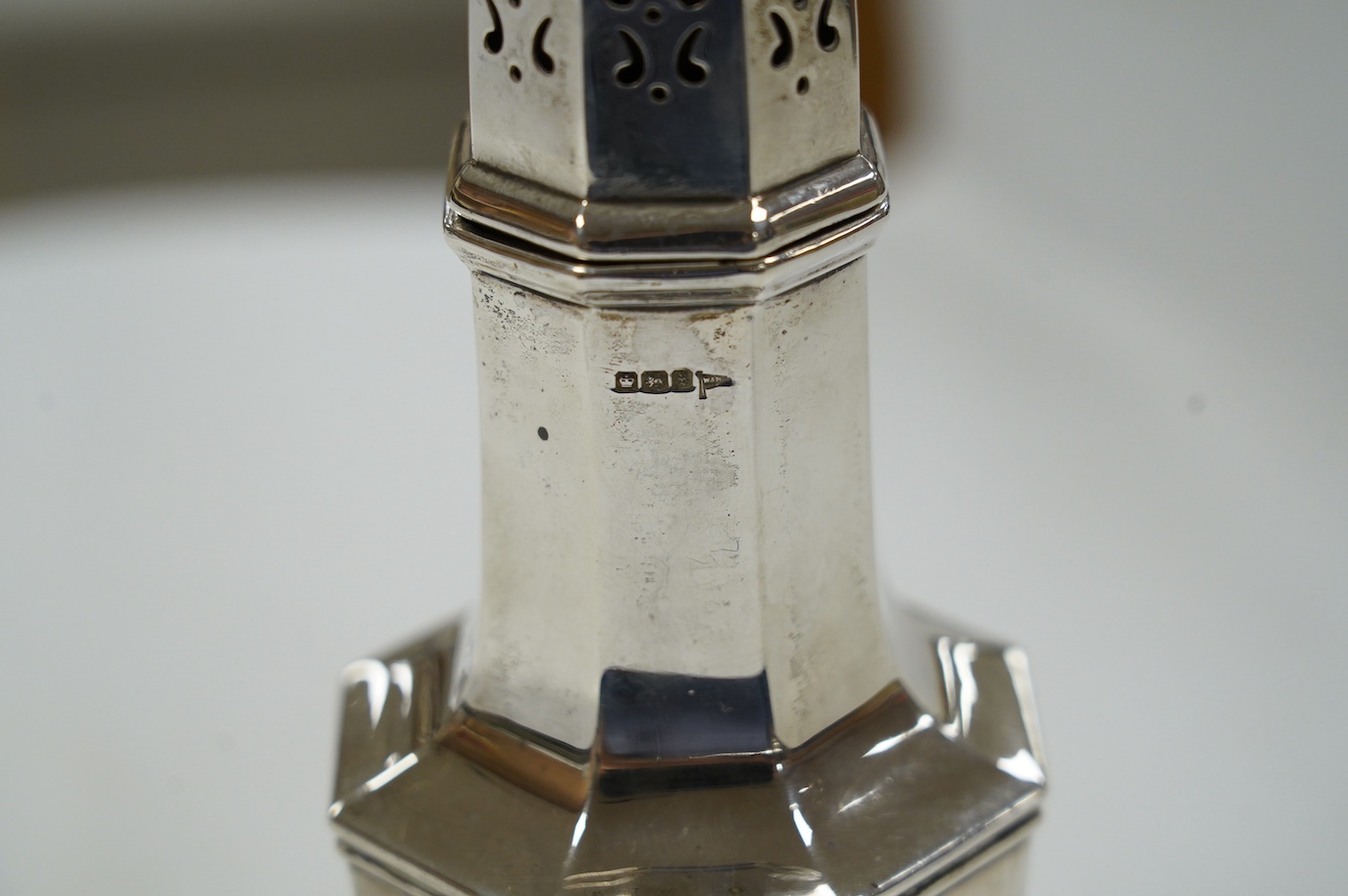 A George V octagonal silver sugar caster, Walker & Hall, Sheffield, 1915, 21cm, 6.4oz. Condition - poor